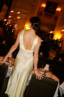 Yellow Eugenie long V-neck nightgown by Bocan Couture, featuring a flowing fabric and elegant design for comfortable sleepwear.