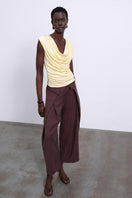 Yellow YLUNE Liquid Drape Top by SÉLONE, featuring a flowy fabric and stylish drape design.