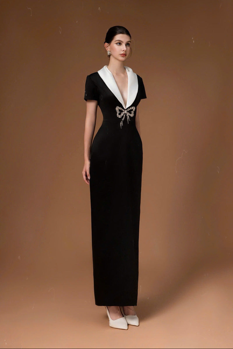 Black long gown with sweetheart bowtie neckline by HACCHIC COUTURE, featuring elegant fabric and a flowing silhouette.