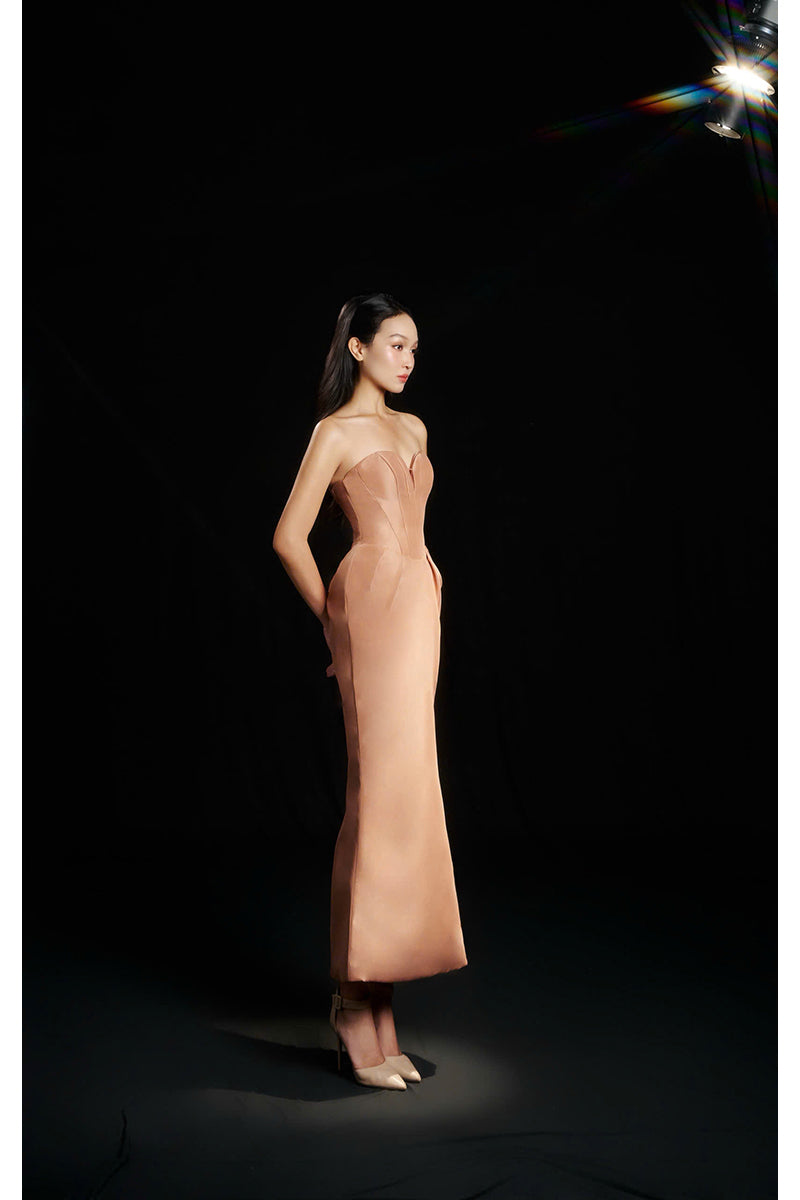 Hacchic Couture Sendra strapless bow dress in nude caramel, elegant gown with a bow detail, smooth fabric, and fitted bodice.