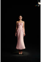 Hacchic Couture Sendra strapless blush pink bow gown displayed on a mannequin with elegant draping and floral accessories.