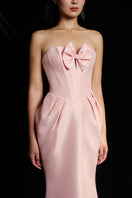 Hacchic Couture Sendra strapless blush pink bow gown with elegant draping and fitted bodice, perfect for formal occasions.