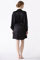 NK IMODE zero waste black robe displayed from the back, showcasing the sustainable design and relaxed fit of this stylish robe.