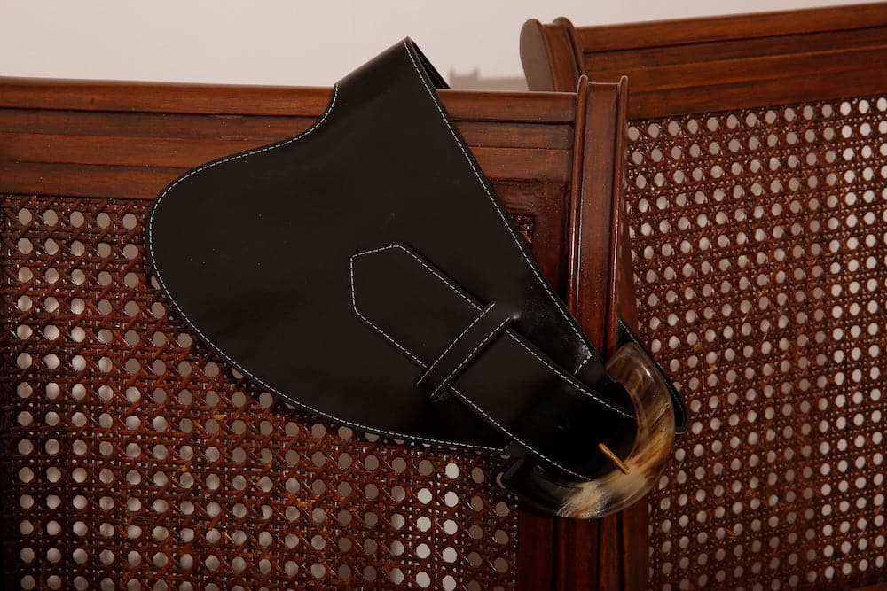 Black leather belt by Adriana Castro with a sleek, minimalist design, perfect for adding sophisticated style to any outfit.