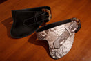 Black leather belt by Adriana Castro with a sleek buckle, designed for stylish and versatile accessory wear.