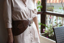 Brown leather belt from Adriana Castro's La Jefa collection, featuring a sleek design and adjustable buckle.