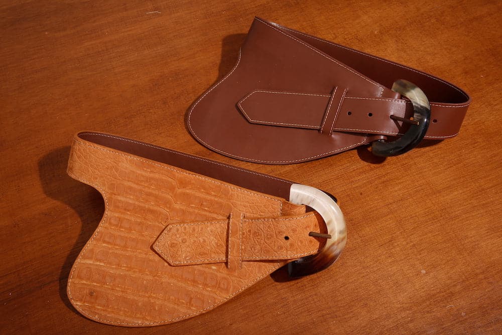 Brown leather belt by Adriana Castro featuring a sleek design, perfect for adding a stylish touch to any outfit.