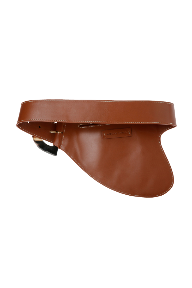 Brown leather belt from Adriana Castro's La Jefa collection with a sleek, polished finish and a classic buckle.