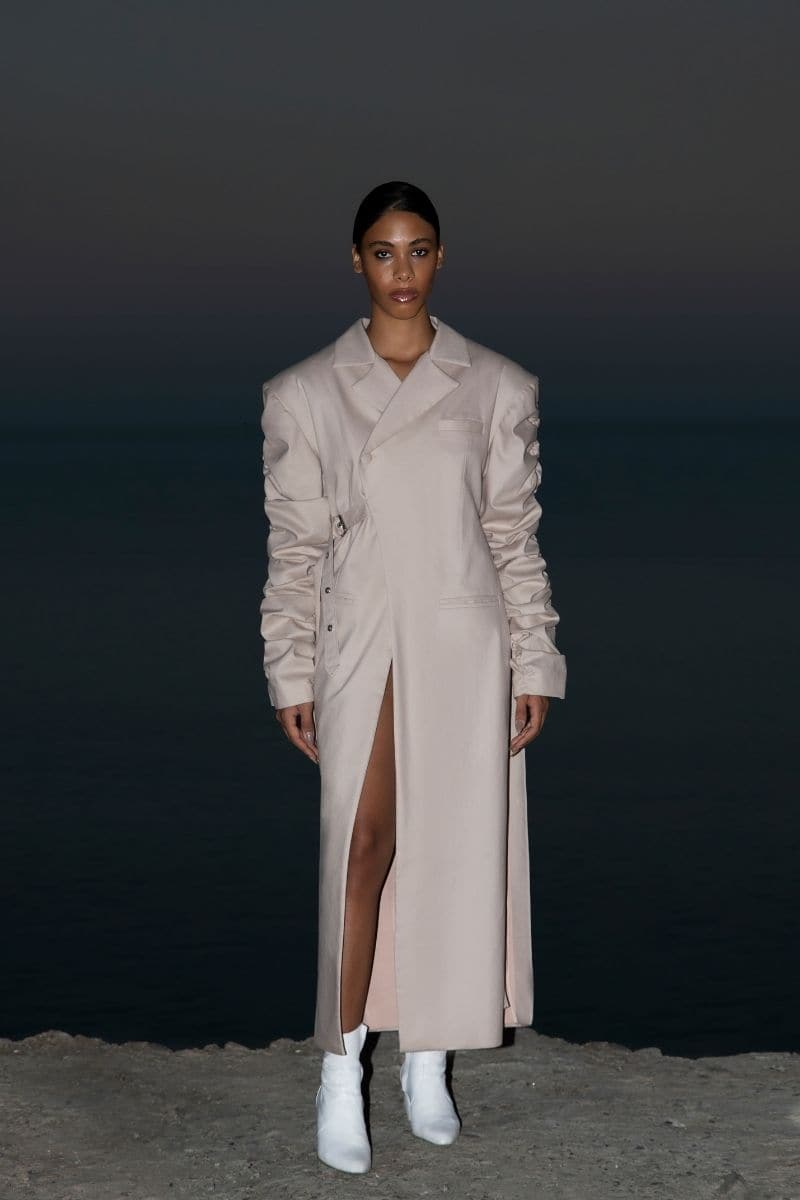Beige crumple-sleeve trench coat by Blikvanger, shown in XS size with textured, crumpled fabric and classic trench design.