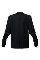 Black crumple-sleeve long blazer by Blikvanger, shown on a mannequin, with tailored fit and classic lapel design.