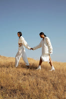 Crumple-sleeve long white blazer by Blikvanger, tailored fit, with textured fabric and classic lapel, shown on a model.