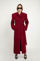 Full-length maroon coat by Blikvanger, structured design, shown hanging with front view and detailed fabric texture.