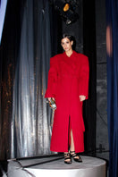 Full-length maroon coat by Blikvanger featuring a structured design, shown hanging on a hanger.