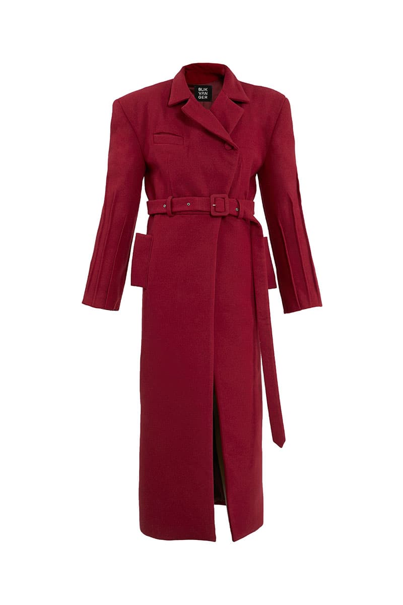 Full-length maroon coat by Blikvanger featuring a structured design, shown hanging on a hanger with front view.