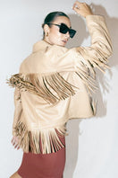 Beige Pyrus Nude fringed leather jacket by Double A, shown on a hanger with detailed fringe and smooth leather texture.