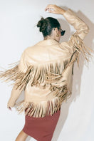 Beige Pyrus nude fringed leather jacket by Double A, featuring tassel details and stylish design, shown on a model.