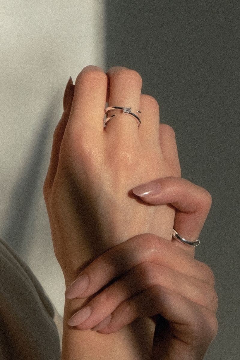 EDXÚ Dew Rhodium Ring showcasing a sleek silver band with polished finish and intricate design details.