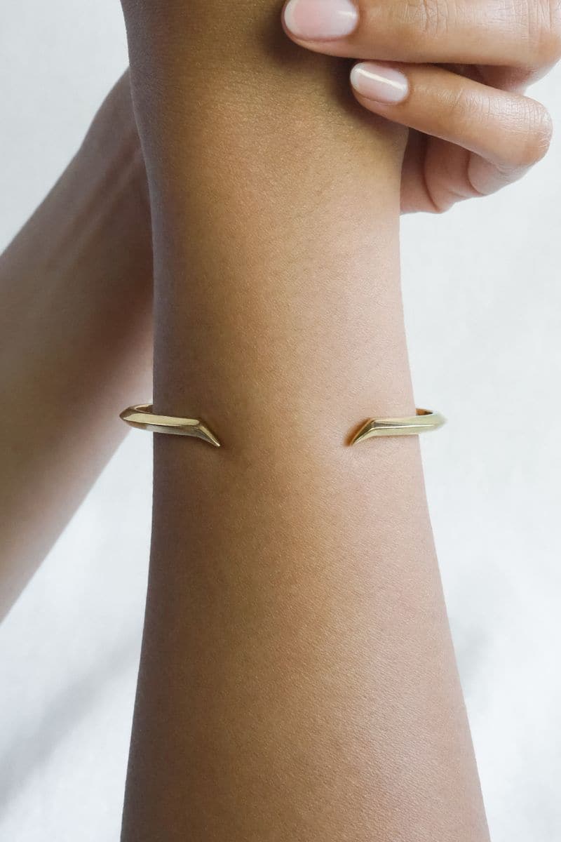 Rose gold Fang Bangle bracelet by EDXÚ featuring a sleek, modern design with a bold fang motif.