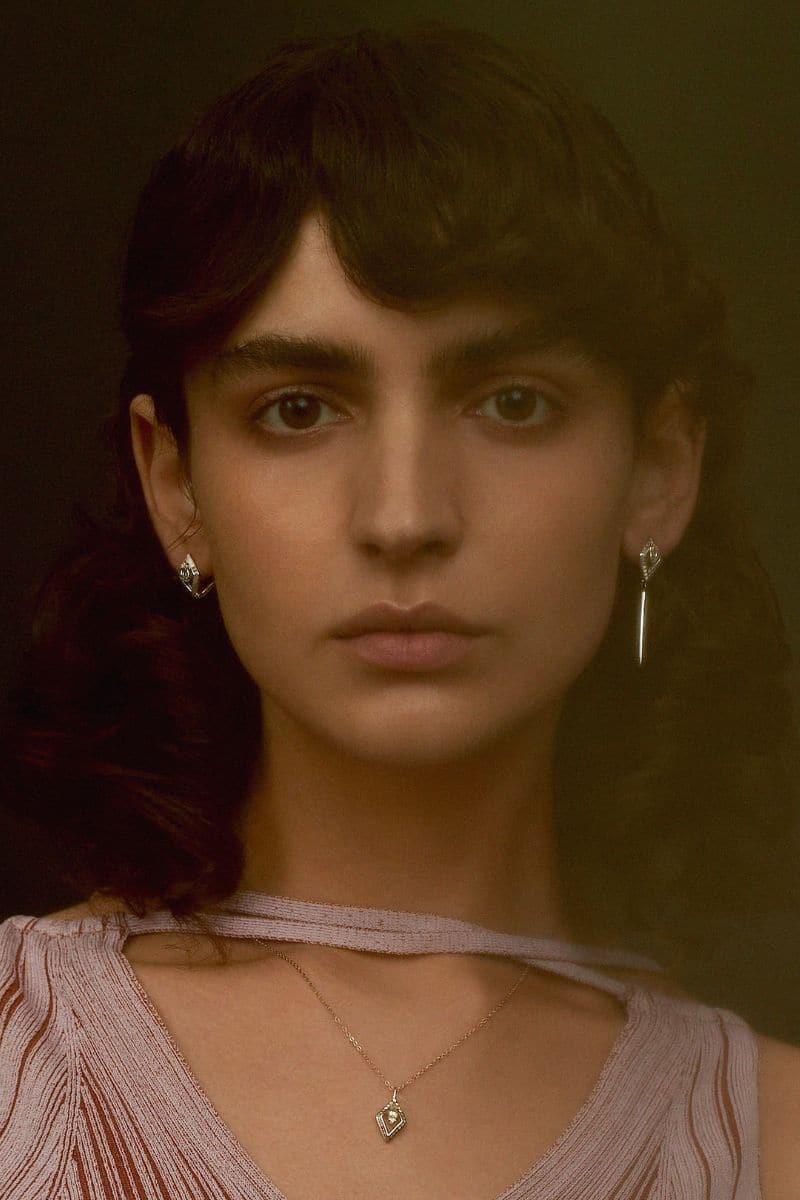 Edxu Kora plated drop earrings in rose gold with blue accents, featuring elegant, dangling design and 18k gold plating.