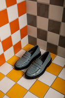 Sky blue CULT MIA X GVASALIA croc-effect leather loafers for women, stylish flats with textured crocodile pattern.