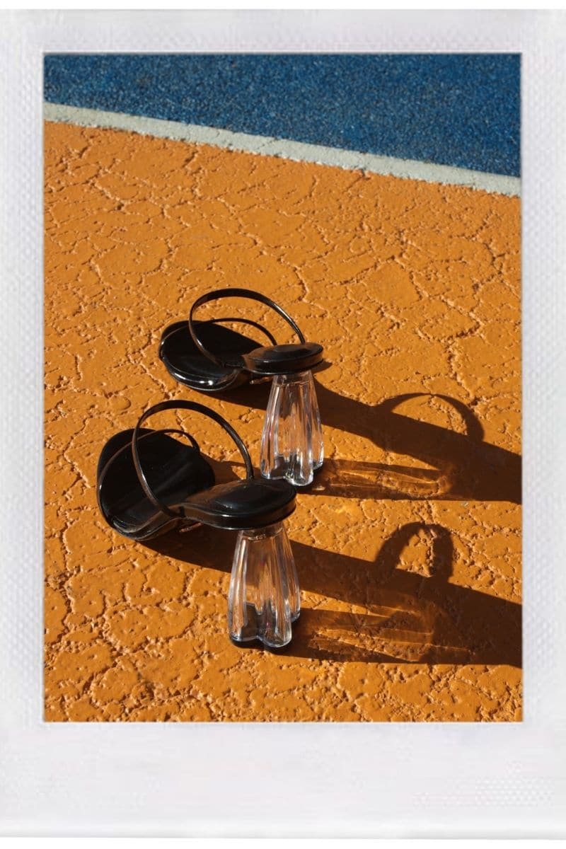 Black patent block heel sandals by House of Atana with transparent glass accents and open toe design.