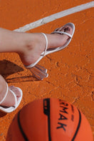 White patent block heel sandals by House of Atana with clear glass accents and comfortable ankle straps.