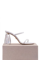 White patent block heel sandals from House of Atana's Fiorellini Glass collection, featuring sleek design and comfortable heel height.