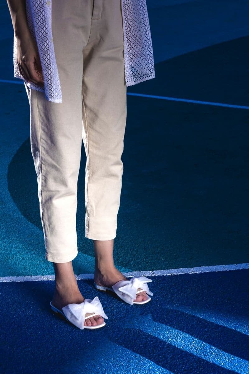 White patent bow sliders flats from House of Atana with a sleek design and stylish bow detail on the upper.