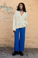 Cream knitted cardigan by La Granni, featuring a cozy knit design, long sleeves, and button closure, perfect for casual wear.