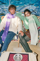 La Granni Palta knitted scarf in pistachio and mint colors, soft and cozy, worn as a stylish accessory for scarves and shawls.