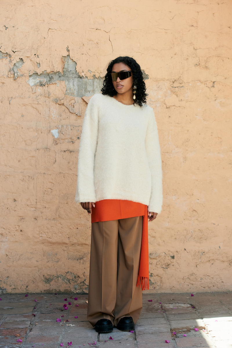 Cream knitted crewneck sweater by La Granni, close-up of soft fabric and classic design in size XS.