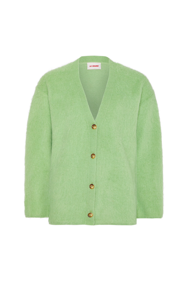 La Granni SURI knitted mint cardigan displayed on a hanger, showcasing its textured knit fabric and cozy style.