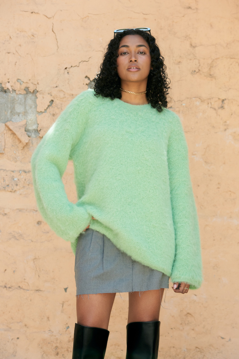 La Granni SURI knitted mint crewneck sweater, close-up view showing soft knit fabric and fitted style.
