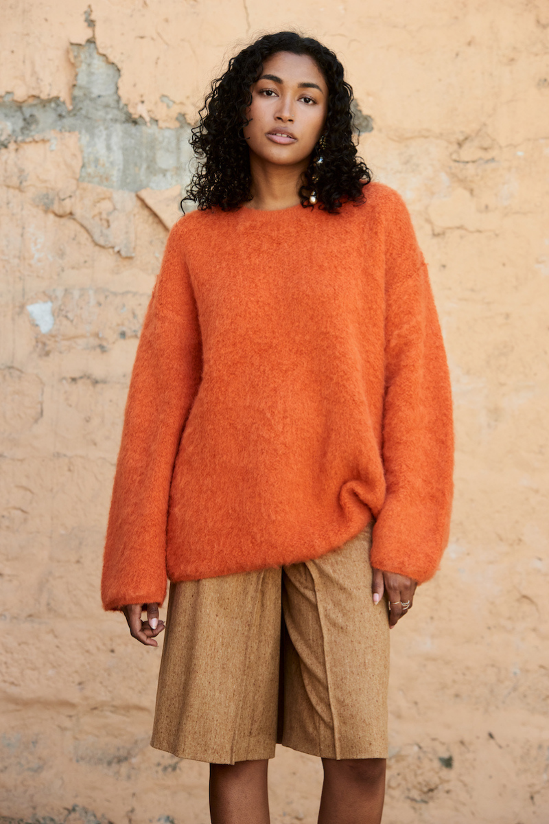 Orange La Granni SURI knitted crewneck sweater with a cozy, textured knit pattern on a plain background.