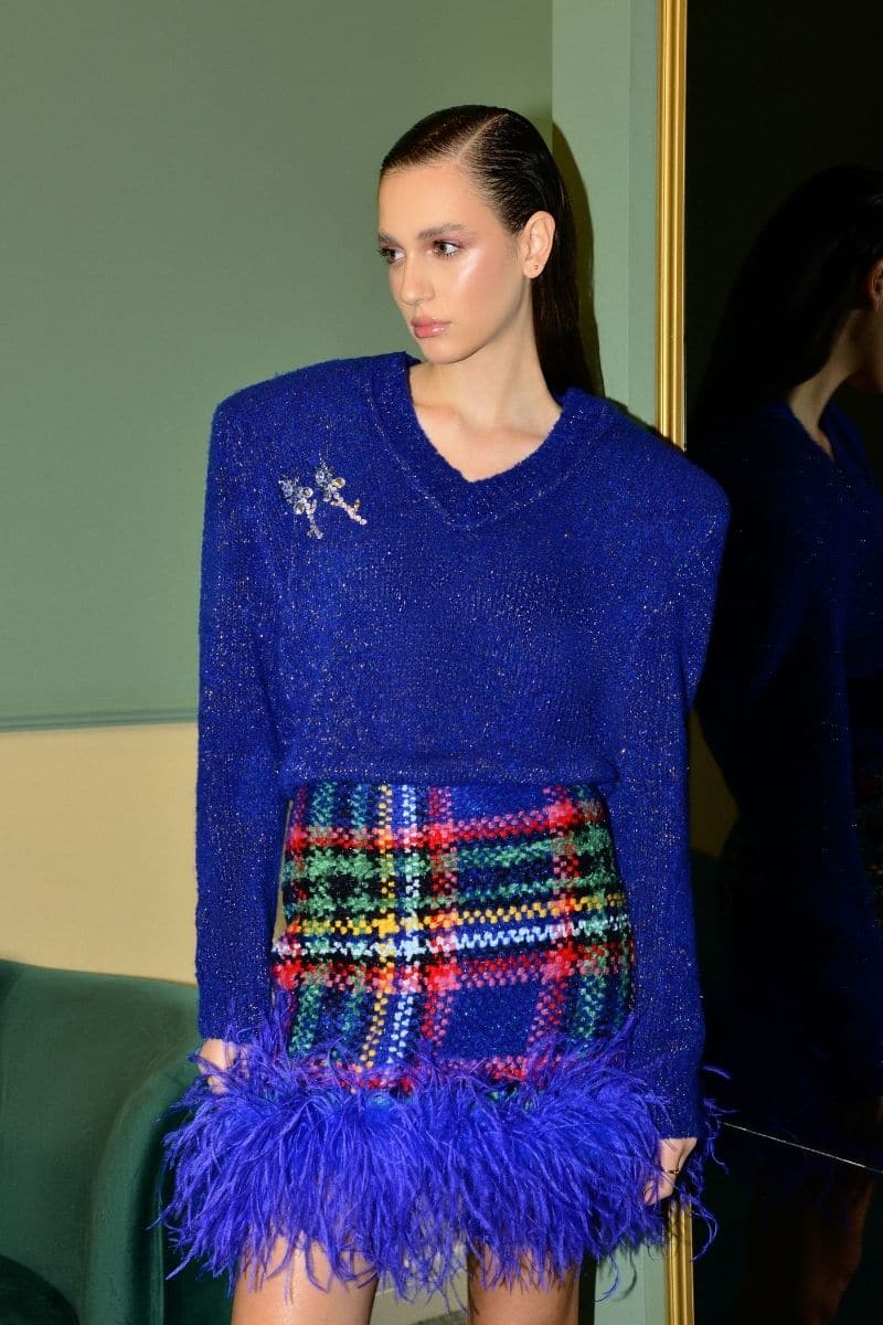 Blue checkered mini skirt by Lalo with feather trim, featuring a stylish and trendy design for casual or dressy wear.