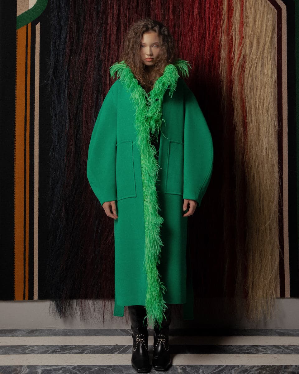 Green belted wool coat with feather detailing from Lalo, showcasing a tailored fit and classic style.