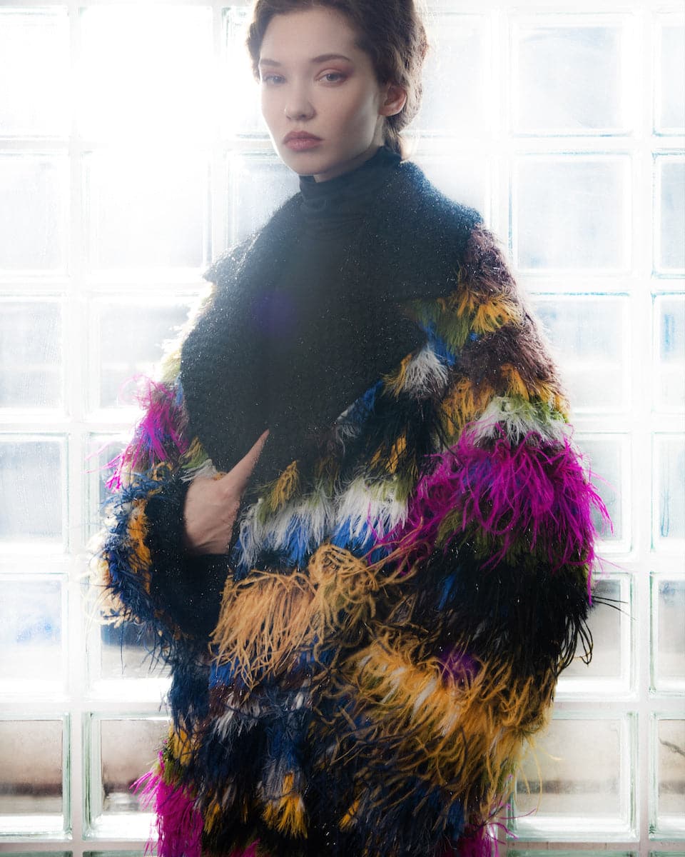 Lalo fringed mohair coat in soft, textured fabric with fringed edges, styled as a cozy and stylish outerwear piece.