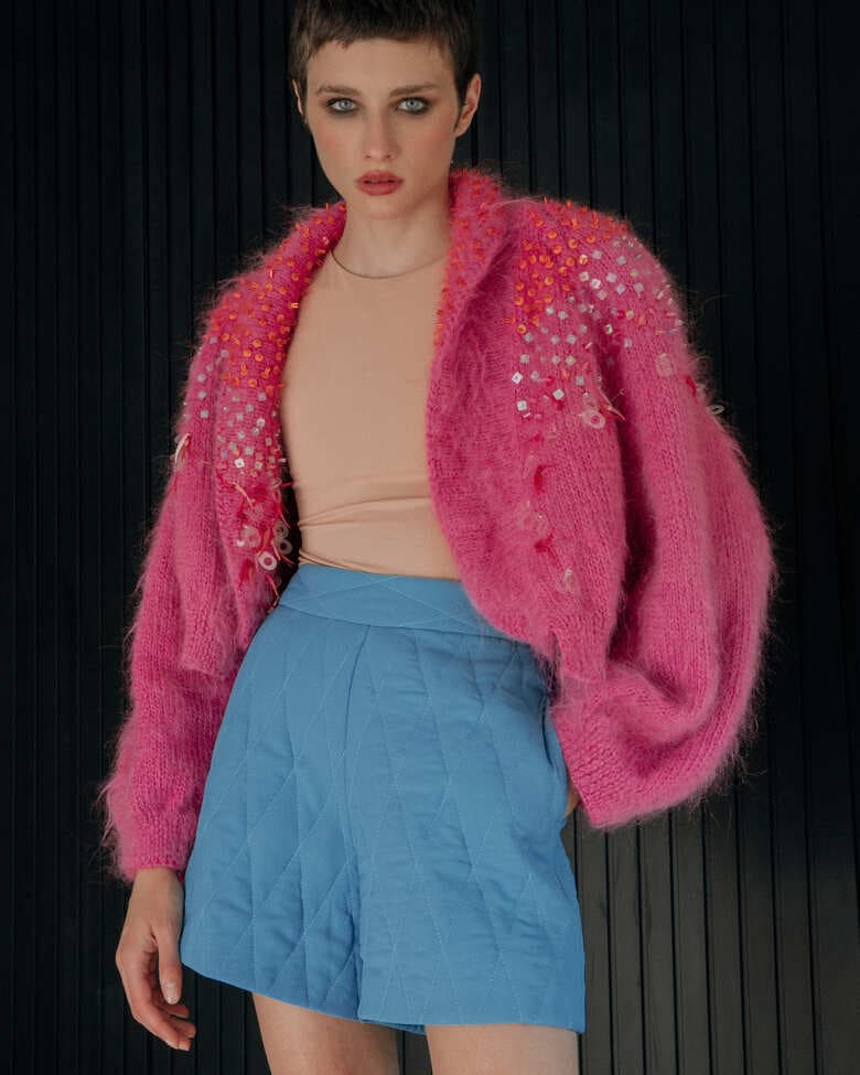 Pink embellished mohair cardigan by Lalo, featuring soft texture and decorative details, shown in a close-up image.