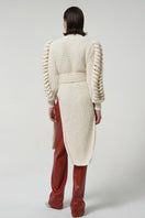 White belted Liya cardigan with knit sleeves, featuring a stylish belt and cozy knit detail on the sleeves.