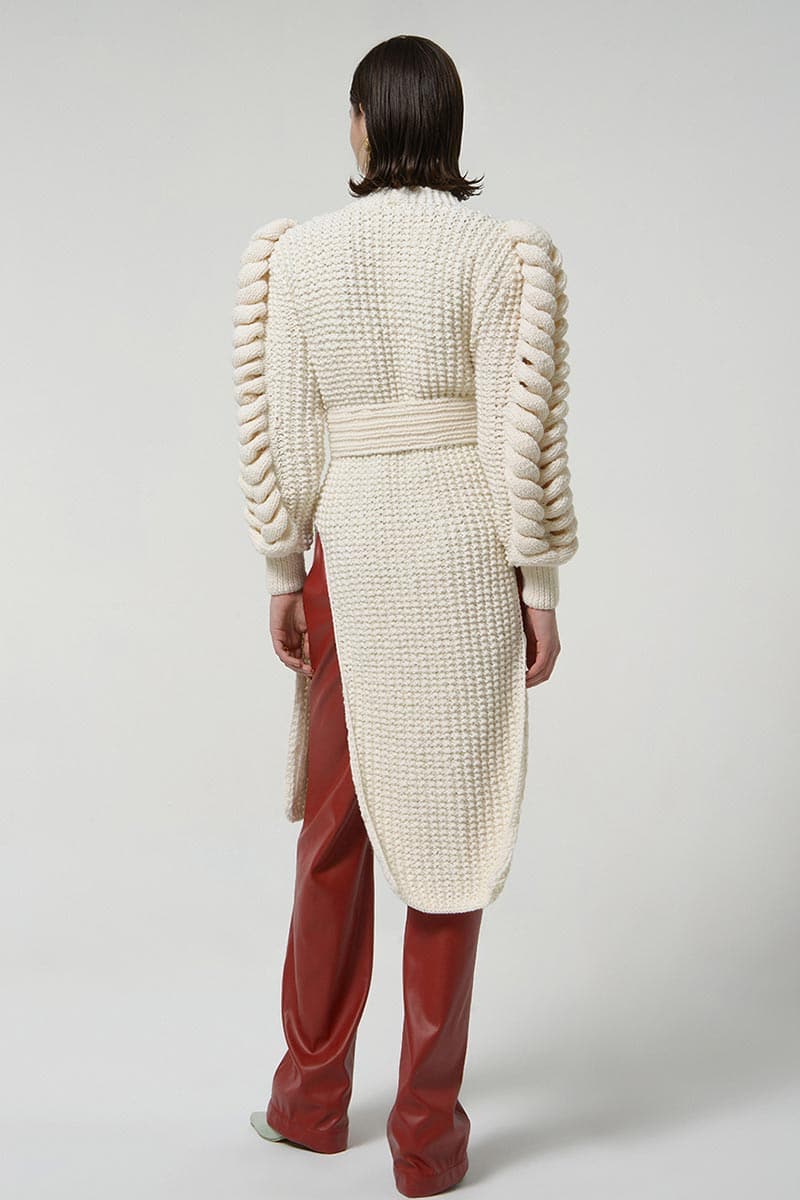 White belted Liya cardigan with knit sleeves, featuring a stylish belt and cozy knit detail on the sleeves.