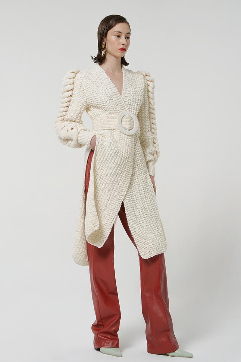 White belted Liya cardigan with knit sleeves, featuring a stylish belt and cozy knit details on the sleeves.