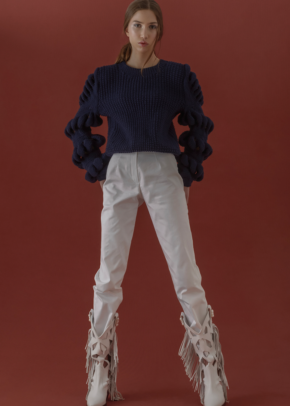 Liya hand-knitted wool-blend black sweater with navy accents, soft and cozy, featuring a classic knit pattern and long sleeves.