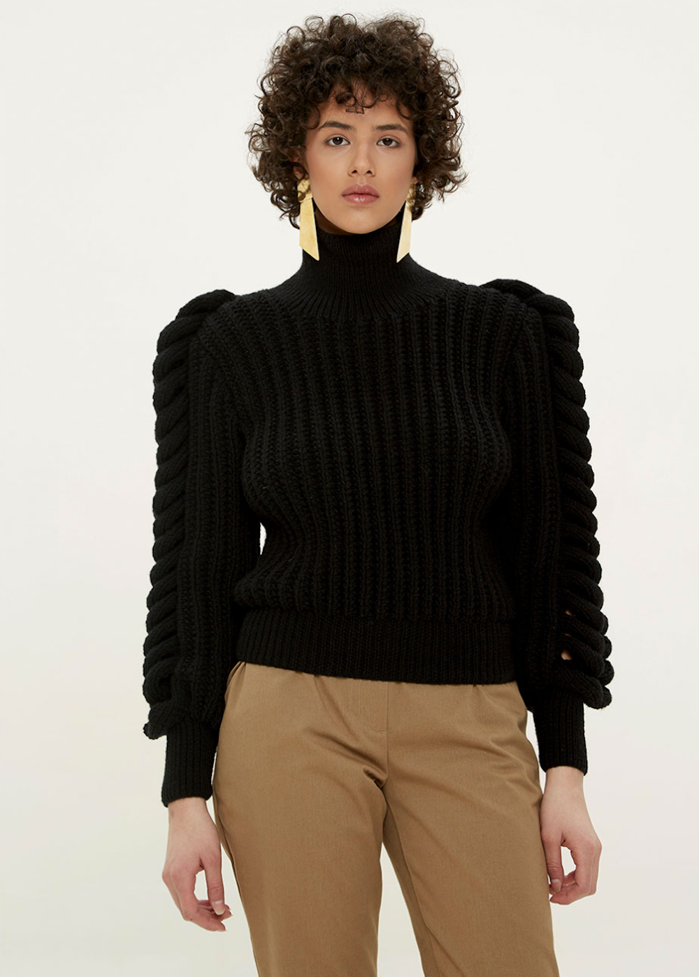 Black high-neck knitted sweater by Liya, showcasing a cozy, stylish sweater with a close-up of the textured knit fabric.