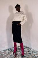 White Liya knitted sweater with fringes, featuring cozy knit texture and stylish fringe details.