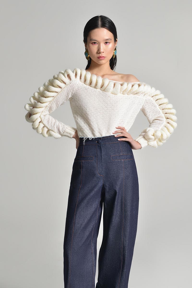 Liya off-shoulder white knit sweater with long sleeves and relaxed fit, stylish and cozy for casual wear.