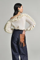 White Liya off-shoulder knit sweater with a cozy, relaxed fit, featuring a stylish off-shoulder design and long sleeves.