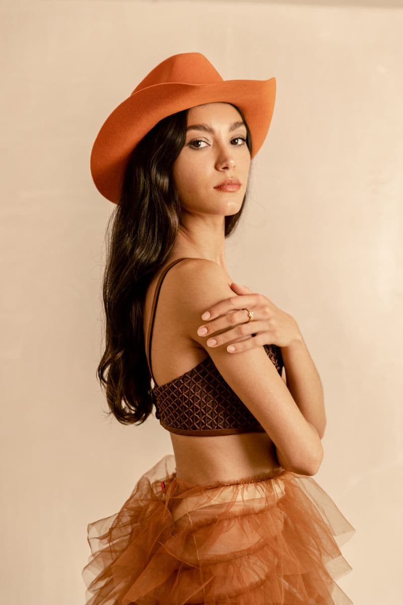 Orange Texan style hat by Modern Monarchie featuring a wide brim and decorative band, perfect for a western-inspired look.