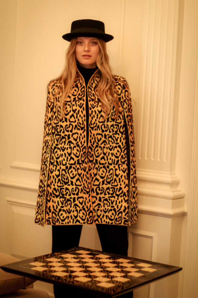 Nadya Shah Bianca leopard-print cape jacket with stylish pattern, displayed on a hanger against a neutral background.