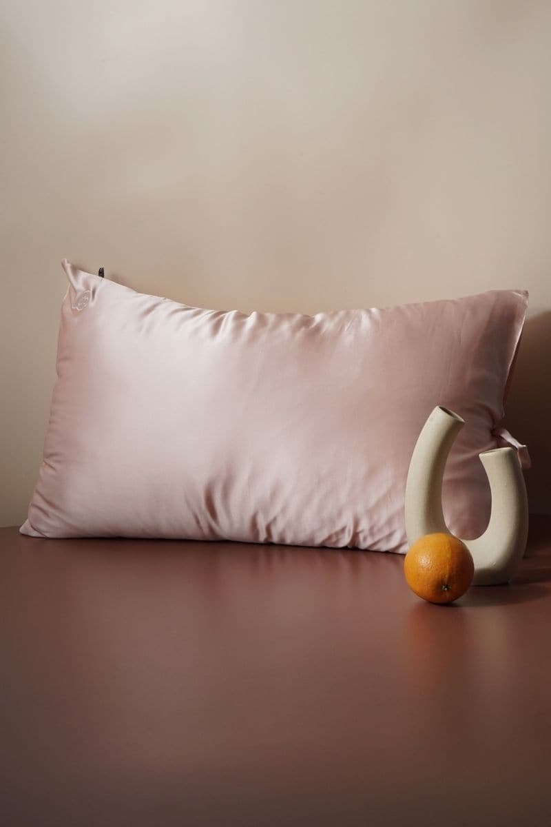Queen-size silk pillowcase in rose pink by Not Just Pajama, showing soft, smooth fabric with elegant stitching.