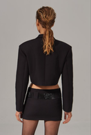 Nué cropped tailored blazer in EU size 38, shown on a hanger, featuring a sleek fit and classic blazer design.